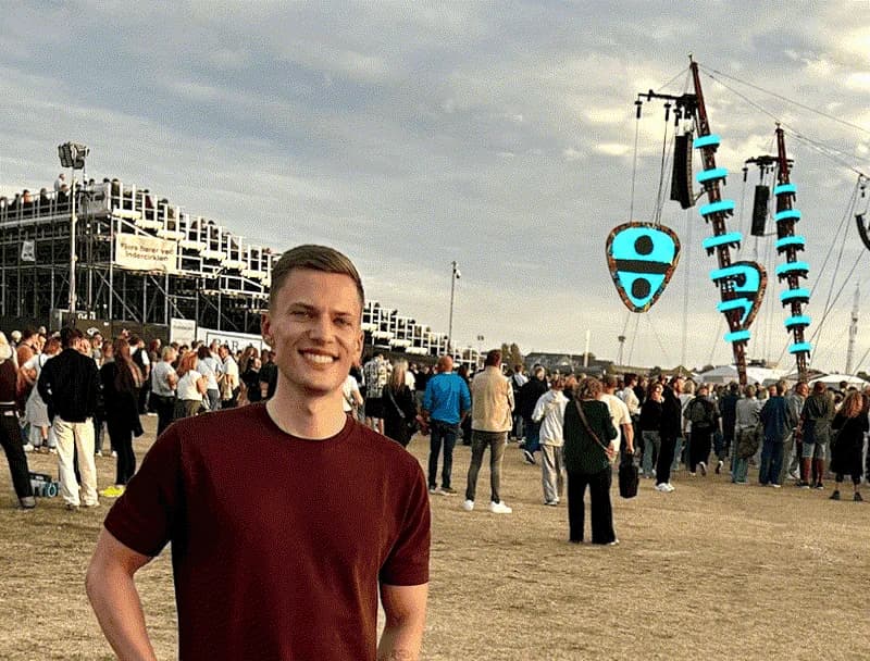 Oliver in a crowd at an outdoor festival