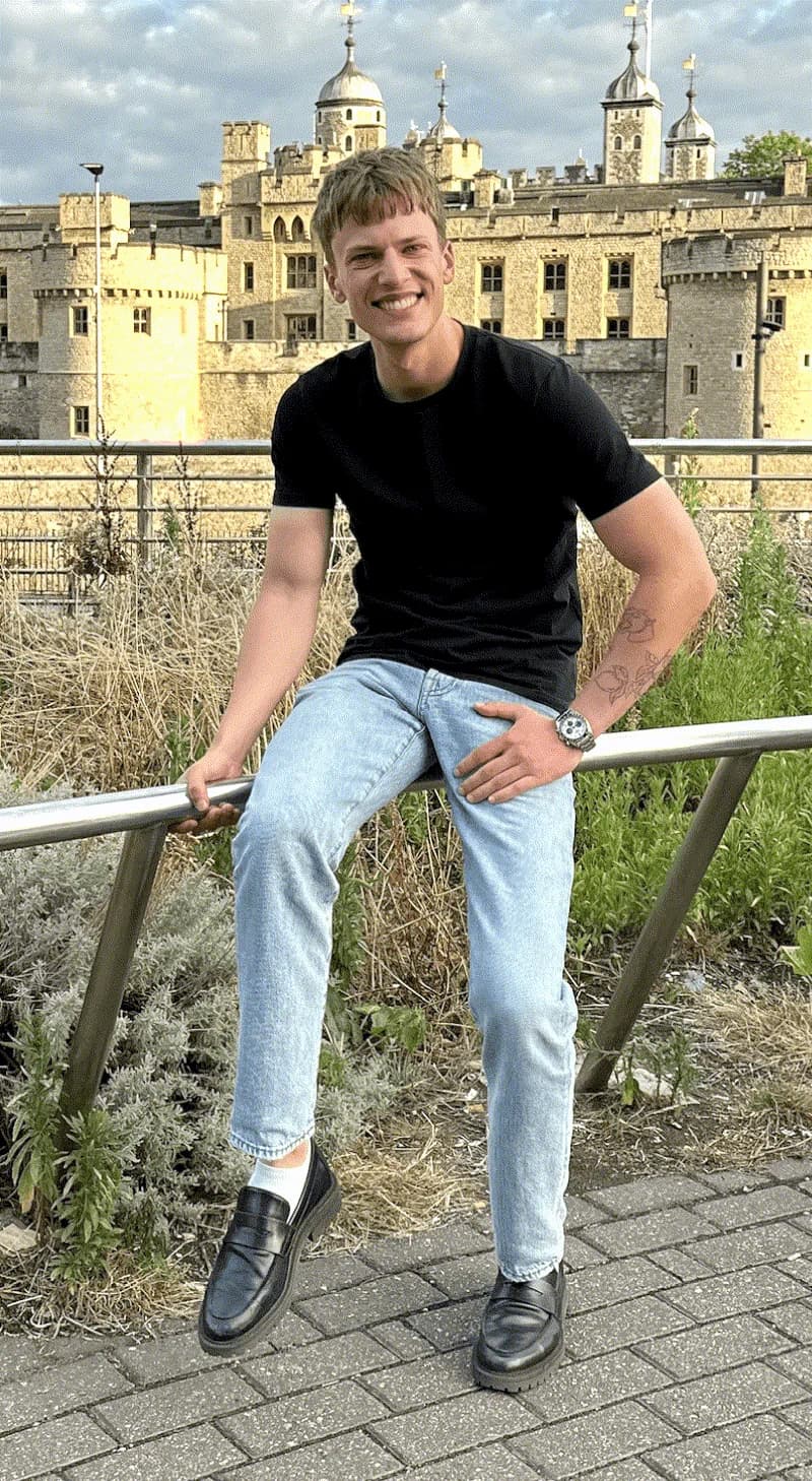 Oliver sitting on a railing in front of the Tower of London